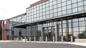 Vestavia Hills Civic Center exterior with a modern glass façade, main entrance, and American flag visible at the front.